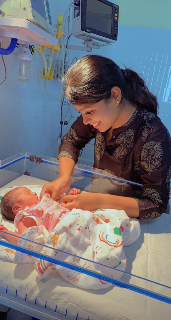 Dr. Ushapriya Sudhakar caring for a newborn baby in a neonatal unit